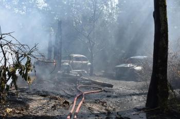 Dissipating hose mist reveals vehicles singed by flames from a barn fire at 207 Ludwig Road, in Hope, Wednesday, Sept. 11, 2024. (Photo by Sarah Thompson)