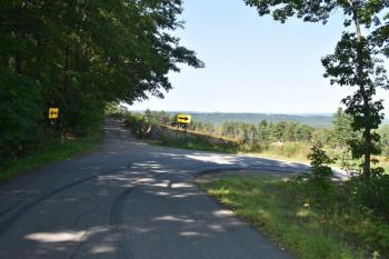 A tight blind corner at the top of a hill make for very slow vehicular traffic on this narrow road. (Photo by Sarah Thompson)