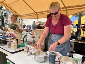 Making and baking blueberry waffles, the way breakfast has been cooked for centuries in Maine, on a wood powered cookstove. (Photo by Lynda Clancy)