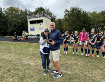 Coach Townsend is presented with a 300-career win plaque and given a game ball from Thursday's night win against Belfast.