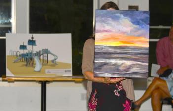 Pictured here at Belfast Rotary Club’s Evening by the Bay gala and auction, the event that launched the 17th annual Belfast Harbor Fest on Aug. 17, are a rendering of the club’s $200,000 centennial playground Legacy Project (left), to be built at City Park in Belfast in 2025, and “Glow,” an original oil painting by Jerri Finch which went to the high bidder at the live auction. Pictured here at Belfast Rotary Club’s Evening by the Bay gala and auction, the event that launched the 17th annual Belfast Harbor Fest on Aug. 17, are a rendering of the club’s $200,000 centennial playground Legacy Project (left), to be built at City Park in Belfast in 2025, and “Glow,” an original oil painting by Jerri Finch which went to the high bidder at the live auction.