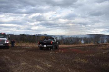 A Union fire truck and a Maine Forest Service truck overlook a wildland fire that ignited Sunday afternoon, Oct. 27, 2024. (Photo by Sarah Thompson)