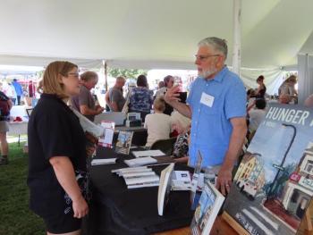 Author Philip C. Baker chats with a festivalgoer at Maine Author's Publishing's Book Festival. Photo courtesy Maine Author's Publishing
