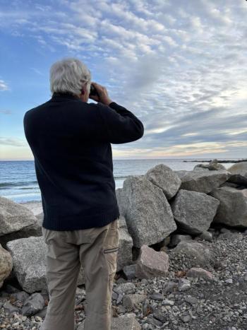 Jeff scanning shorebirds at Fortune's Rocks in Biddeford. A cave swallow had been seen nearby earlier that day, but the authors didn't know it at the time. Courtesy of Allison Wells