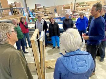 GO Logic CEO Alan Gibson describes window construction to tour participants. (Photo courtesy Martha Laitin)