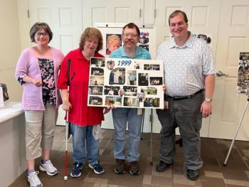 From left, Retta Goughnour, BillieJo Stewart, Jared Stewart, and John Paul Carr pose with a poster showcasing memories from 1999 during the 25th anniversary celebration of Bank of America’s Belfast Support Services. (Photo courtesy Bank of America) From left, Retta Goughnour, BillieJo Stewart, Jared Stewart, and John Paul Carr pose with a poster showcasing memories from 1999 during the 25th anniversary celebration of Bank of America’s Belfast Support Services. (Photo courtesy Bank of America)