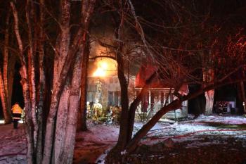Well after big flames were suppressed, sparks found oxygenation from a new hole in the roof. (Photo by Sarah Thompson)