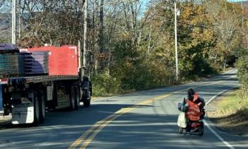 Michelle Bishop operates her powered wheelchair on John Street in November 2023