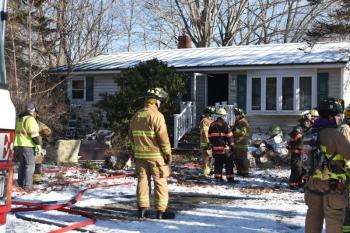 Long after the smoke cleared, interior-trained firefighters continued to clean debris, saturate hot spots, and search for the origin of the fire at 906 Depot Road, in Union. (Photo by Sarah Thompson)