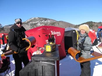 Tim Savard and Emily Eplan model two handmade toboggan shelves to hold their drinks. Photo by Kay Stephens