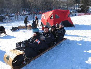 Members of Big Ash Sled practicing the full tuck. Photo by Kay Stephens