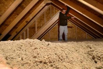 a man standing in an attic. 
