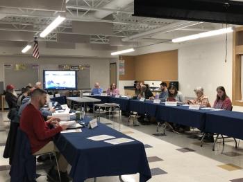 a group of adults at a conference table