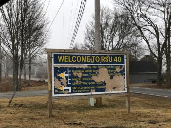 a dilapidated peeling sign greets visitors at RSU40 middle and high schools