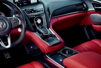 For 2025, the RDX cabin has been upgraded with more leather and Ultrasuede, a roomier bin in the console, easier access to the phone charging pad and more ambient lighting. The knob in the center is the drive mode selector; beneath that lie the P-R-N-D buttons, with a second setting on the Drive button for S, Sport. And below them is the computer touchpad. For 2025, the RDX cabin has been upgraded with more leather and Ultrasuede, a roomier bin in the console, easier access to the phone charging pad and more ambient lighting. The knob in the center is the drive mode selector; beneath that lie the P-R-N-D buttons, with a second setting on the Drive button for S, Sport. And below them is the computer touchpad.