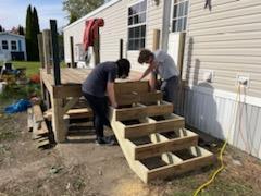 Student volunteers install a ramp, enabling an elderly homeowner to age in place. (Photo courtesy Midcoast Habitat for Humanity)
Student volunteers install a ramp, enabling an elderly homeowner to age in place. (Photo courtesy Midcoast Habitat for Humanity)
