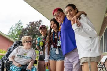 In 2024, Pine Tree Camper Cassie Oakes (Alexander, ME) spent a barrier-free week of fully accessible summer camp on the shores of North Pond making new friends and spending time with counselors from Maine and abroad, including: Brandi Place (Morrill, ME), Daniela Ochoa-Diaz (Rionegro, Colombia), Lauren Grant (Gardiner, ME) and Marina Rodriguez (Andalusia, Spain). On Saturday, May 17, parents, families and caregivers are invited to meet the team and experience Pine Tree Camp first hand. More information at w