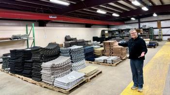 David Whitney poses for a photo in his warehouse.