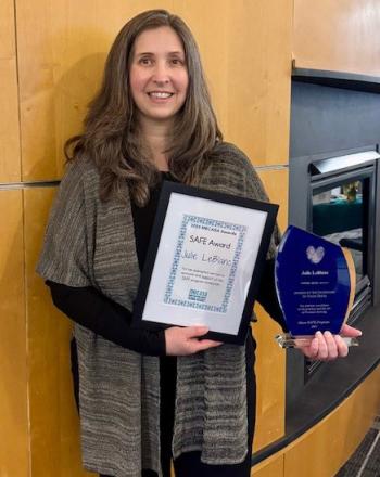 Julie LeBlanc stands with her Maine SAFE Award given by the Maine Coalition Against Sexual Assault (MECASA). (Photo courtesy MaineHealth)