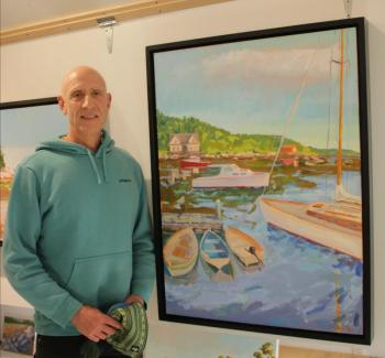 Stephen Florimbi stands next to his winning painting, “Coming and Going.” (Photo courtesy Maine Boats, Homes & Harbors)