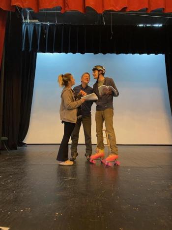 AnnMarie Lowerre, James Cook, and rollerskating Jack Sullivan rehearse for The Drowsy Chaperone. (Photo courtesy Watts Hall Community Players)