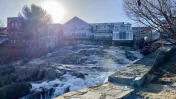 The Montgomery Dam sits at the outflow of the Megunticook River, sending water hurtling underneath the Camden Deli and out into the harbor below. Years into contentious deliberations about what to do with the ailing structure, the town still hasn’t decided whether to remove the dam or maintain it. Photo by Stephanie McFeeters. camden dam