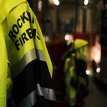 A uniform jacket hangs in the Rockland, Maine Fire House. (Photo by David Troup)