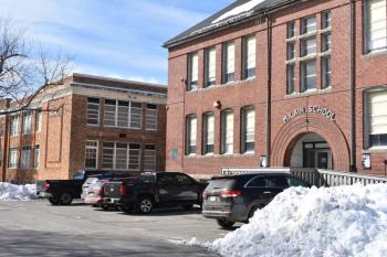 As a developer is named for a long anticipated affordable housing project at the McLain School building, in the foreground, the fate of the Lincoln Street Center, in the background, is questioned. (2018 file photo by Sarah Thompson)