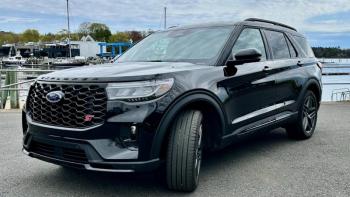 The red ST badge and black grille denote the 400-horsepower performance variant of the 2025 Ford Explorer; other visual clues include red brake calipers and these blacked-out 21-inch aluminum wheels. The view out over the high, squared-off nose is distinctly pickup-truck. This color is Agate black Metallic. The red ST badge and black grille denote the 400-horsepower performance variant of the 2025 Ford Explorer; other visual clues include red brake calipers and these blacked-out 21-inch aluminum wheels. The view out over the high, squared-off nose is distinctly pickup-truck. This color is Agate black Metallic.
