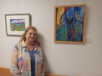 Artist Camilla Jewett stands with some of her works, now on display at MaineHealth Waldo Hospital. (Photo courtesy MaineHealth Waldo Hospital)
