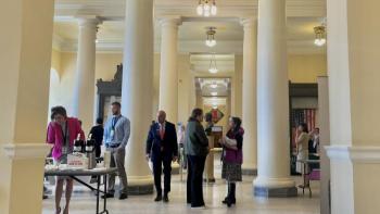 people gather in the halls of the statehouse