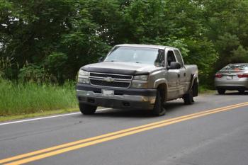 While All Directions hauls the car away, the pickup truck sits idle in front of a first reponder's car. (Photo by Sarah Thompson)