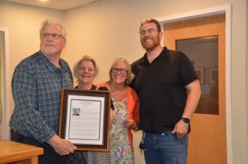 Richard Remsen, with his sister Kit Aroneau, wife Shirley, and their son, Isaac, at the May 30 dedication of the Rockport Town Report to Richard for his support and work on behalf of the town. c