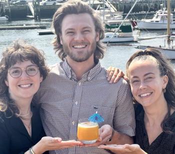 Salt Wharf Managers Mackenzie Gassett, Jake Smith, and Crystal Longo with their top-selling fresh passion fruit and pineapple "Vacation Land" cocktail that is their "Into the Light!" offering in July. (Photo by Patrisha McLean) Salt Wharf Managers Mackenzie Gassett, Jake Smith, and Crystal Longo with their top-selling fresh passion fruit and pineapple "Vacation Land" cocktail that is their "Into the Light!" offering in July. (Photo by Patrisha McLean)