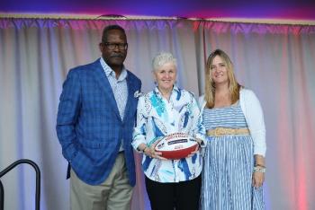 Patriots Pro Football Hall of Famer Andre Tippett (far left) and Gillette’s VP of Communications & Community Affairs, Global Grooming, Kara Buckley congratulate Maureen Keeley from The Center for Grieving Children for being selected as a 2025 Myra Kraft Community MVP Award winner. During the June 3 luncheon, the Kraft family, the Patriots Foundation and Gillette awarded $275,000 in grants to 26 New England nonprofits. The Center for Grieving Children received a $10,000 grant in honor of Maureen’s volunteer efforts. (Photo courtesy Eric J. Adler/New England Patriots) Patriots Pro Football Hall of Famer Andre Tippett (far left) and Gillette’s VP of Communications & Community Affairs, Global Grooming, Kara Buckley congratulate Maureen Keeley from The Center for Grieving Children for being selected as a 2025 Myra Kraft Community MVP Award winner. During the June 3 luncheon, the Kraft family, the Patriots Foundation and Gillette awarded $275,000 in grants to 26 New England nonprofits. The Center for Grieving Children received a $10,000 grant in honor of Maureen’s volunteer
