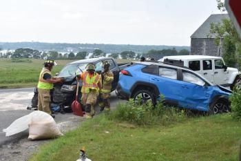 A dark colored pickup truck and a blue colored passenger car were involved in a crash Tuesday, July 1, on St. George Road at the entrance to Westbrook Street. In this picture, items are being put into another vehicle that was not involved in the incident. (Photo by Sarah Thompson)
