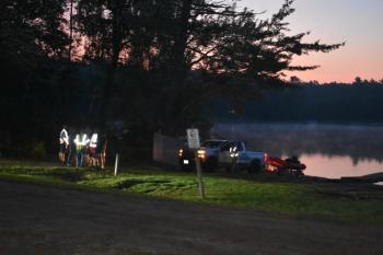As the Union rescue boat is pulled from the water, Union firefighters confirm their plan to hand over all operations to the Maine Warden Service as the search continues for an overdue paddle boarder. (Photo by Sarah Thompson)