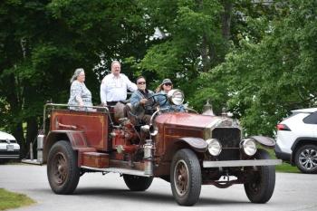 Chief Keller arrives in style with this chauffeur from the Town Office down the road. (Photo by Sarah Thompson)