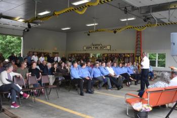 A wider angle of the Hope Corner Fire Station. More guests lined the wall along the left side of this picture. Members of the Hope Volunteer Fire Dept. (Photo by Sarah Thompson)