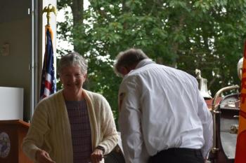 Select Board member Sarah Ann Smith returns to her seat after hugging Keller. (Photo by Sarah Thompson)