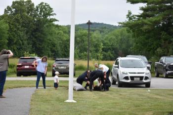 One of Keller's grandchildren watches with interest as Camden firefighters plant their gift to Keller of an apple tree in hopes of a fruitful future for HVFD. (Photo by Sarah Thompson)