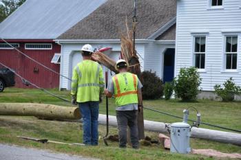 The bottom portion of a snapped utility pole is pulled from the ground following a single-vehicle crash on Hathorne Point Road, July 22, 2025. (Photo by Sarah Thompson)