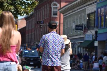 Spectators of the Maine Lobster Festival "Big Parade" come prepared to capture lasting memories Aug. 2, 2025. (Photo by Sarah Thompson)