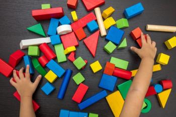 hands playing with blocks