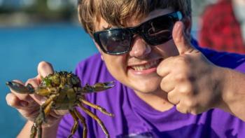Youth learn about invasive green crabs, including how to cook, crack and eat them, during an October 2024 fishing activity at the 4-H Camp and Learning Center at Blueberry Cove in St. George. (Photo courtesy of University of Maine Cooperative Extension) c