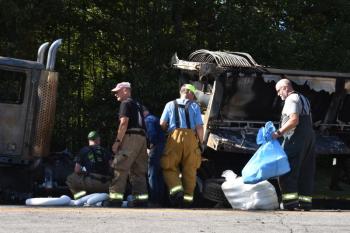 Fire crews mop up fluids from a truck fire incident. (Photo by Sarah Thompson)