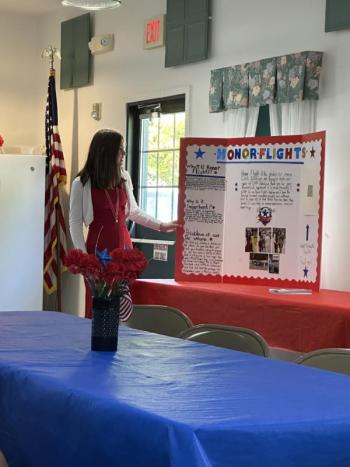 South Portland Middle School 8th grader and Maine State C.A.R. President Ellie Zelinski talks about her state project to raise $1000 for Honor Flight. (Photo courtesy Mary Kay Felton) Student stands with her posterboard for Honor Flight talk
