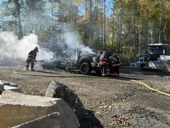 White smoke drifts away from the remains of a pickup truck that caught fire. (Photo by Katie Maynard)