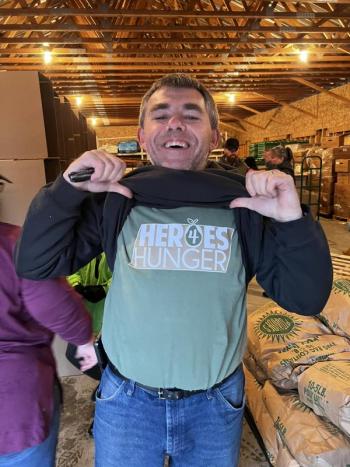 Volunteer shows off his Heroes 4 Hunger T-shirt