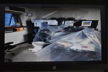 Offices and computers are protected from rain storms and plumbing problems by plastic sheets.